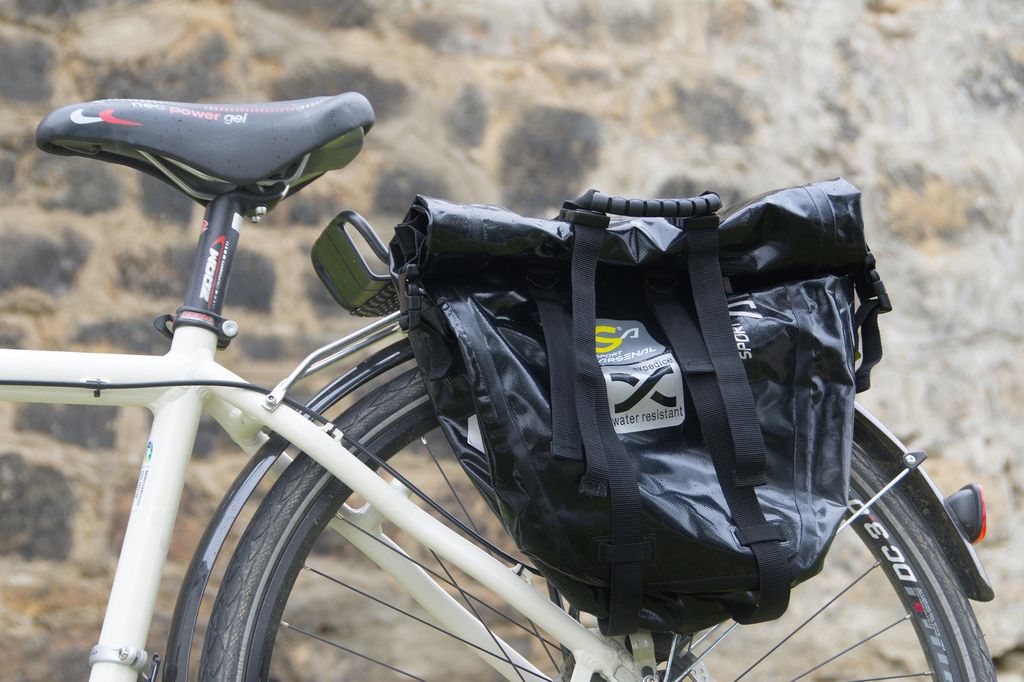 Waterproof and spacious cycling bag on the rear carrier of the trekking bike